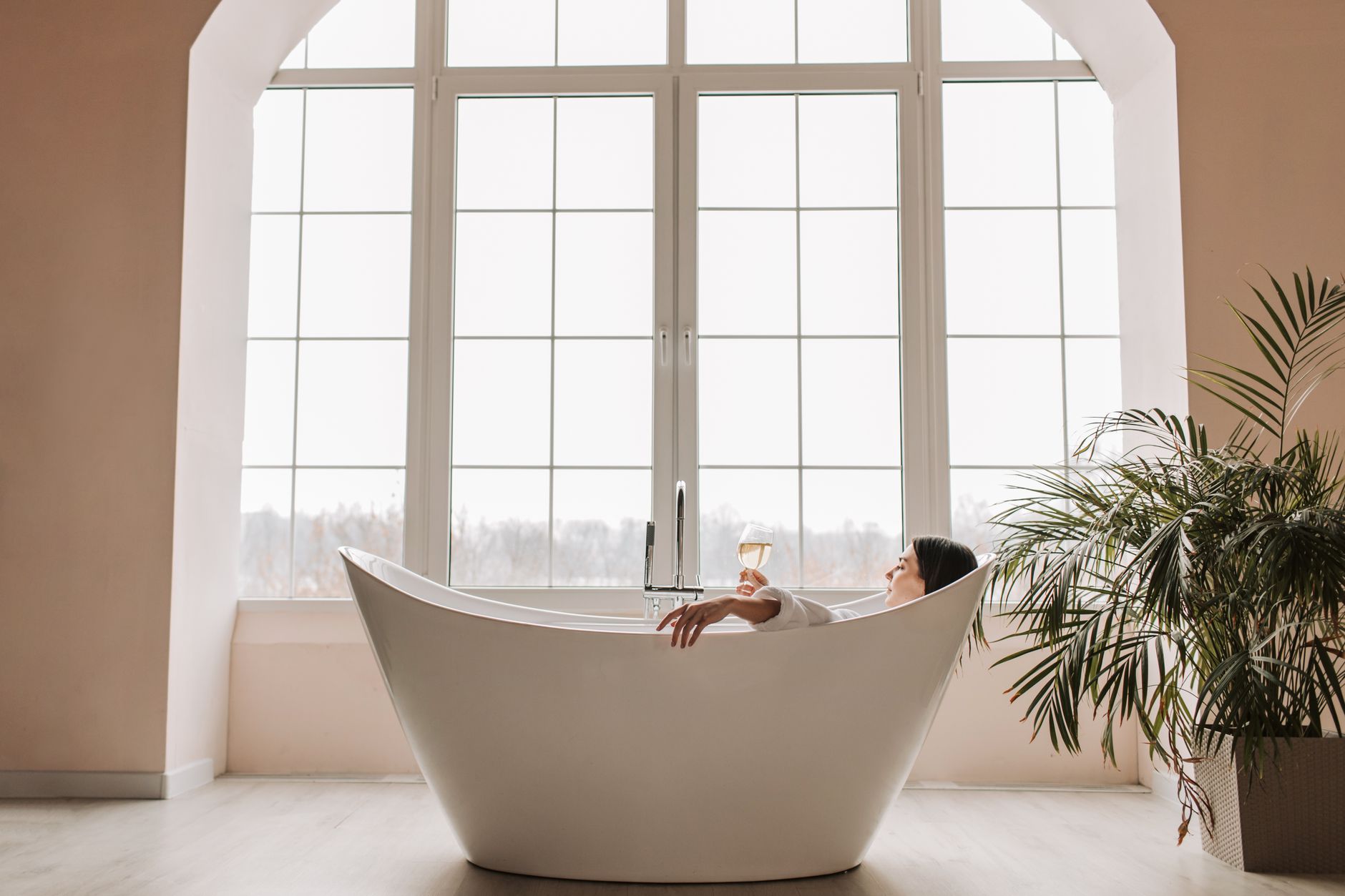 A deep soaking tub by a bright window